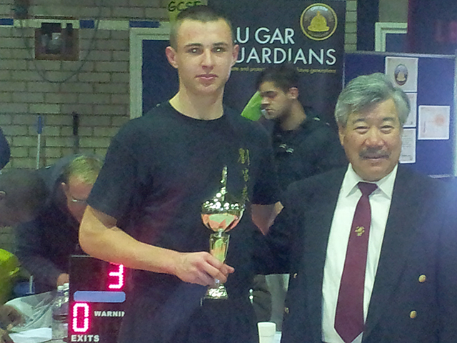 Jake receiving his trophy from Master Yau at the BKFA Nationals