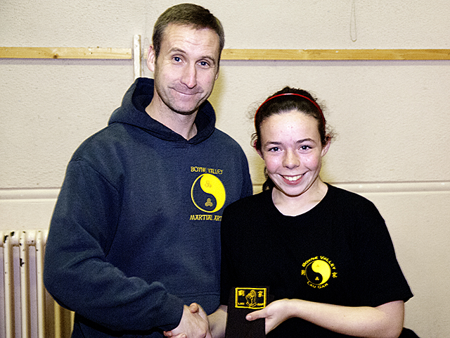 Jennifer receiving her Brown Sash from Sifu Derek Dawson