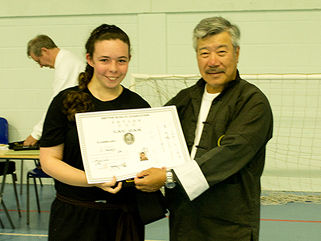 Jennifer receiving her Black Sash from Master Yau