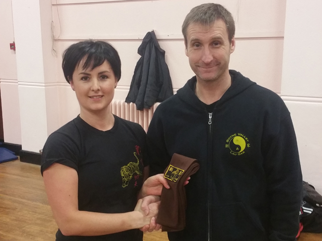 Carly Anderson receiving her Brown Sash from Sifu Derek Dawson