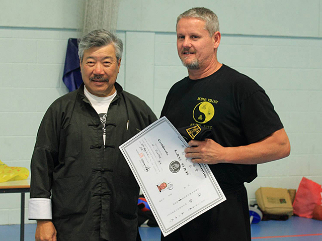 Warrick Bowler receiving his Black Sash from Master Yau at the BKFA Summer Course
