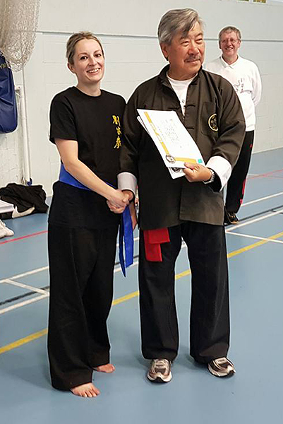Danielle at the Summer Course, receiving her Orange Sash from Master Yau