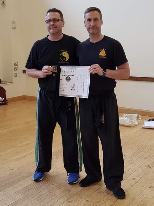 Simon Hugill receiving his 3rd Degree Black Sash and Certificate from Sifu Derek Dawson.