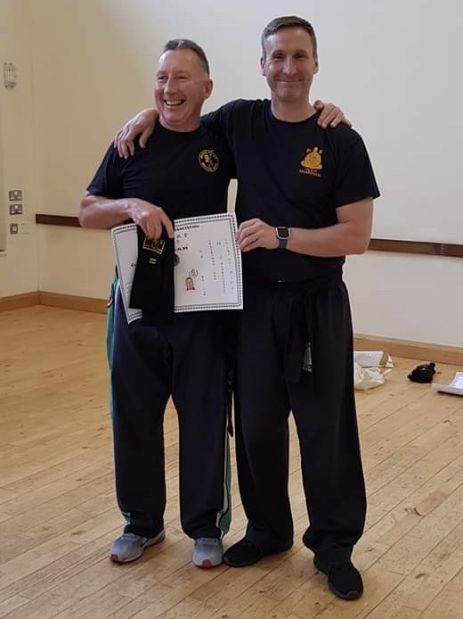 John O'Neill receiving his 2nd Degree Black Sash and Certificate from Sifu Derek Dawson.