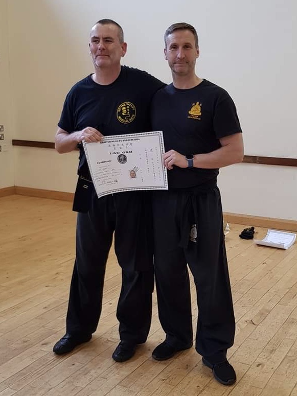 Micheal Lynch receiving his 2nd Degree Black Sash and Certificate from Sifu Derek Dawson.