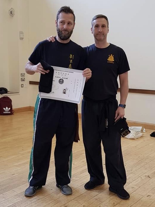 Glen Chegwidden receiving his Black Sash and Certificate from Sifu Derek Dawson.