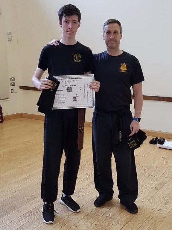 Patrick Maguire receiving his Black Sashes and Certificate from Sifu Derek Dawson.
