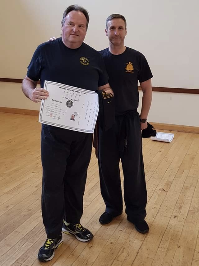 Sean Collard receiving his Black Sash and Certificate from Sifu Derek Dawson.