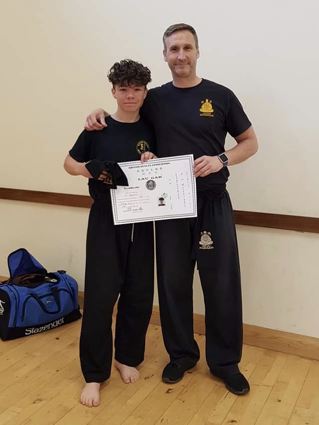 Nathan Hegarty receiving his Black Sash and Certificate from Sifu Derek Dawson.