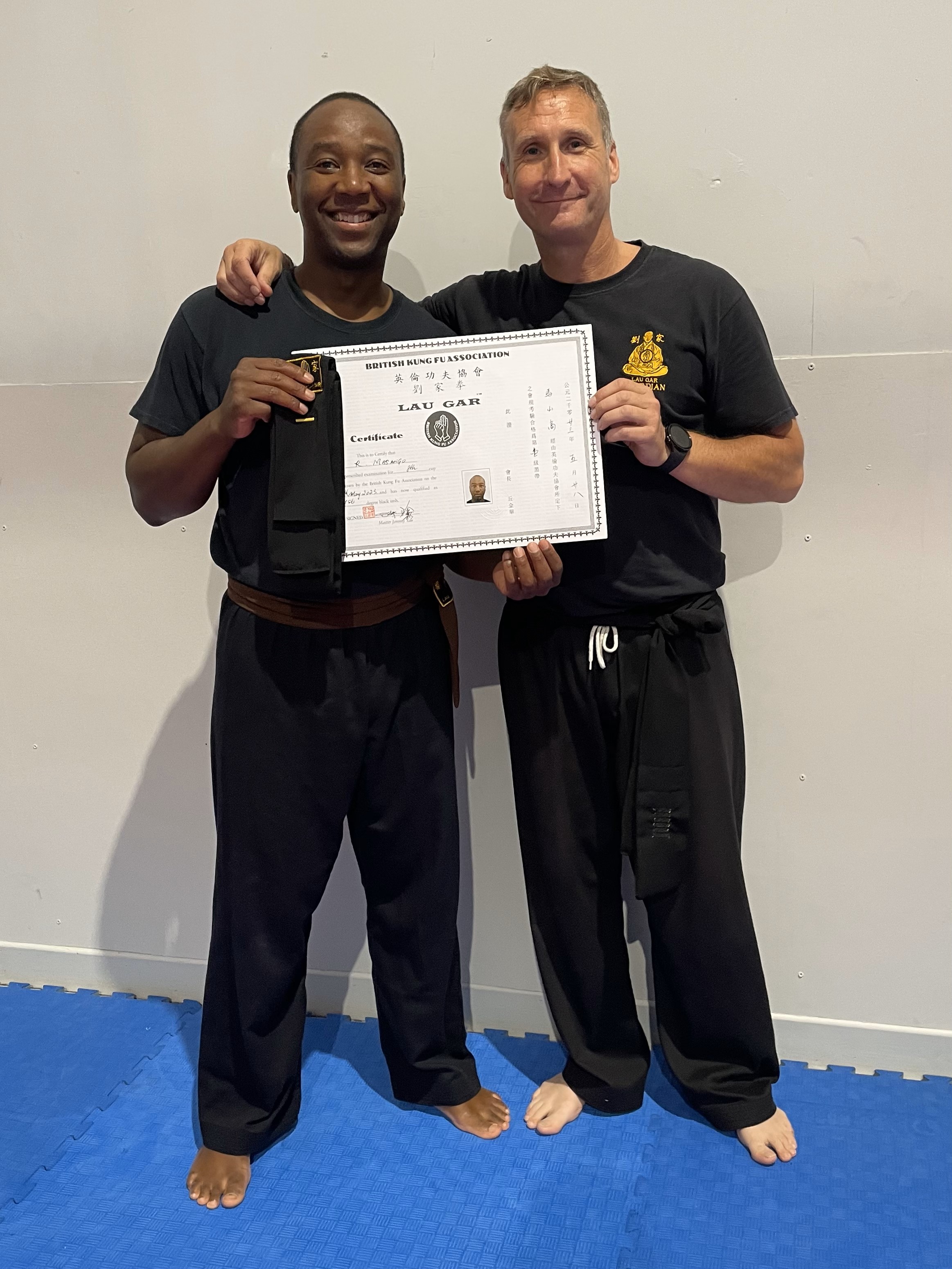 Ranga Masango receiving his Black Sash and Certificate from Sifu Derek Dawson.